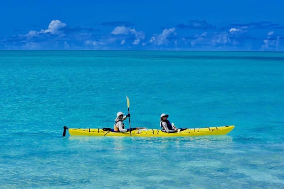 two NOLS participants paddle a yellow double kayak in Baja