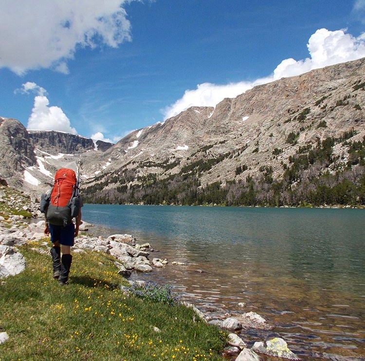 Backpacker along a lake in the Wind River Range