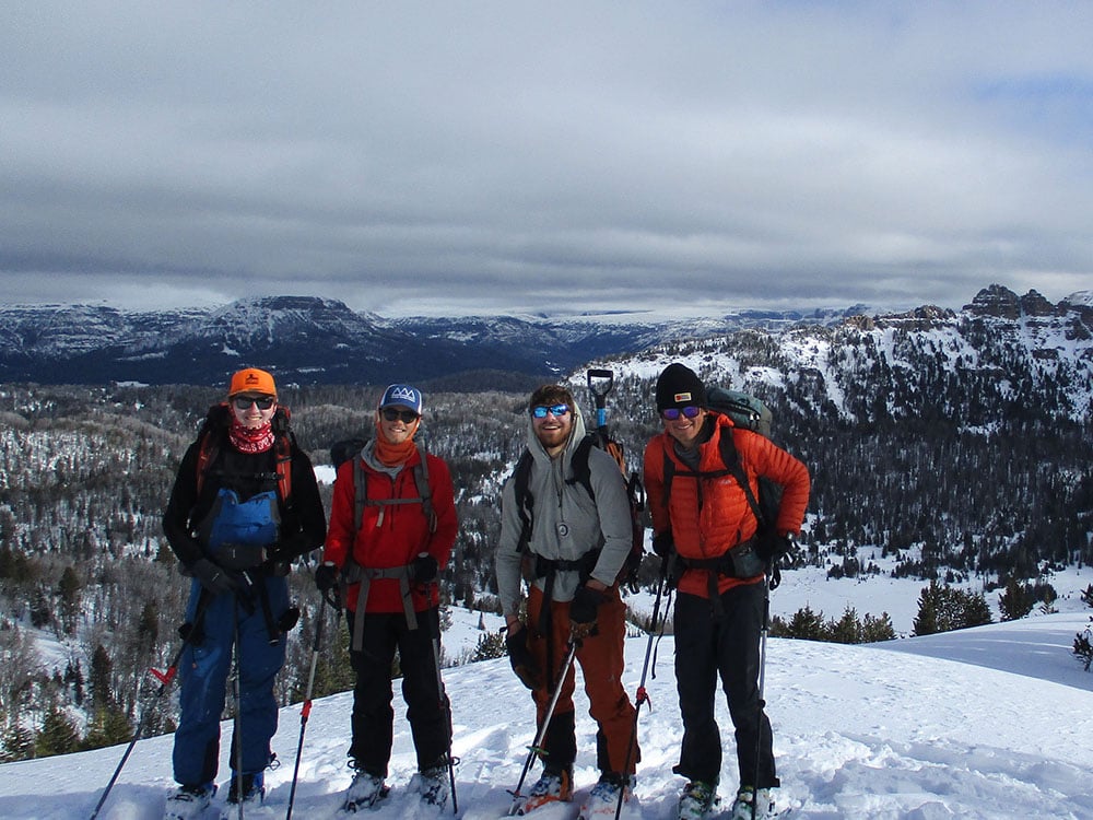 Four students backcountry skiing in the mountains