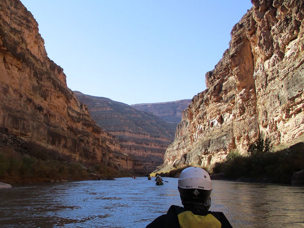 Canoeing on calm river in a steep desert canyon
