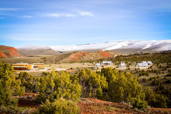 NOLS Wyss Campus in Red Canyon with snowy foothills in the background