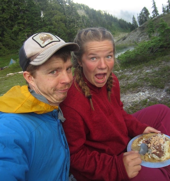 NOLS student and instructor make goofy faces while eating backcountry burritos