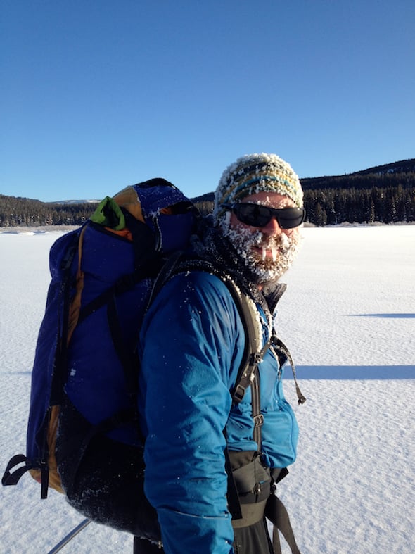 smiling NOLS winter course participant with frosty beard and hat