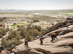NOLS students climb rock slab on a semester in the Rockies