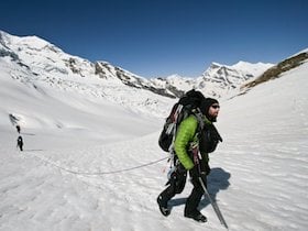 NOLS students mountaineering on a snowy slope in the Himalaya