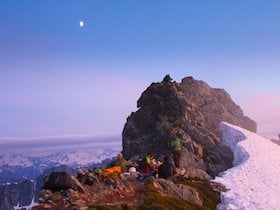 NOLS students mountaineering atop a snowy ridge at sunrise in Squamish, British Columbia