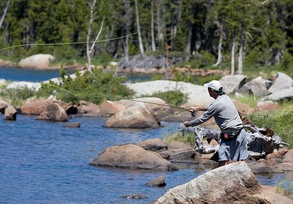 NOLS participant fly fishing in the Rockies on an alumni trip