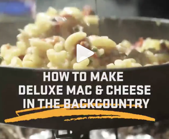 instagram video on how to make deluxe mac & cheese in the backcountry with image of mac & cheese on campstove