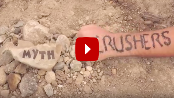 NOLS myth crushers video with myth written on rock and crushers written on arm