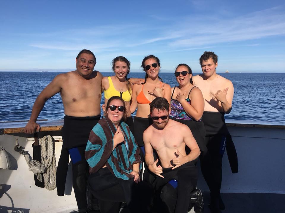 A smiling group of students preparing to dive