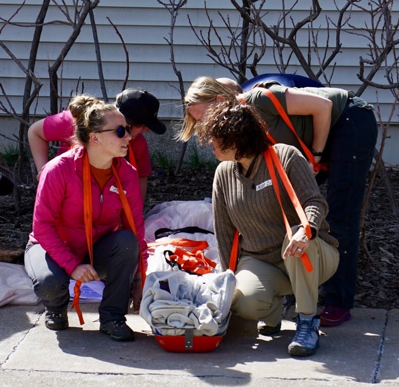 NOLS wilderness medicine students practice caring for a student on a litter