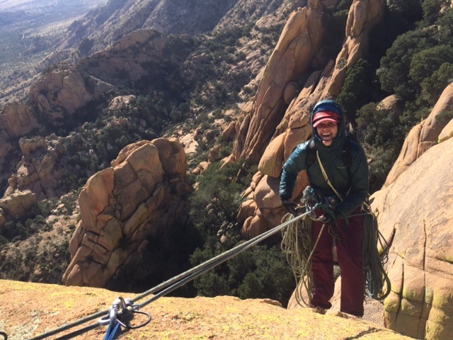 smiling woman rappelling on a sunny day in Arizona's Cochise Stronghold