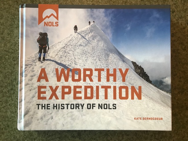 NOLS History Book with snowy mountaineering picture on the cover