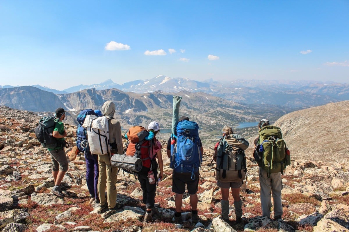 Group backpacking in the Wind River Range pauses high on a ridge