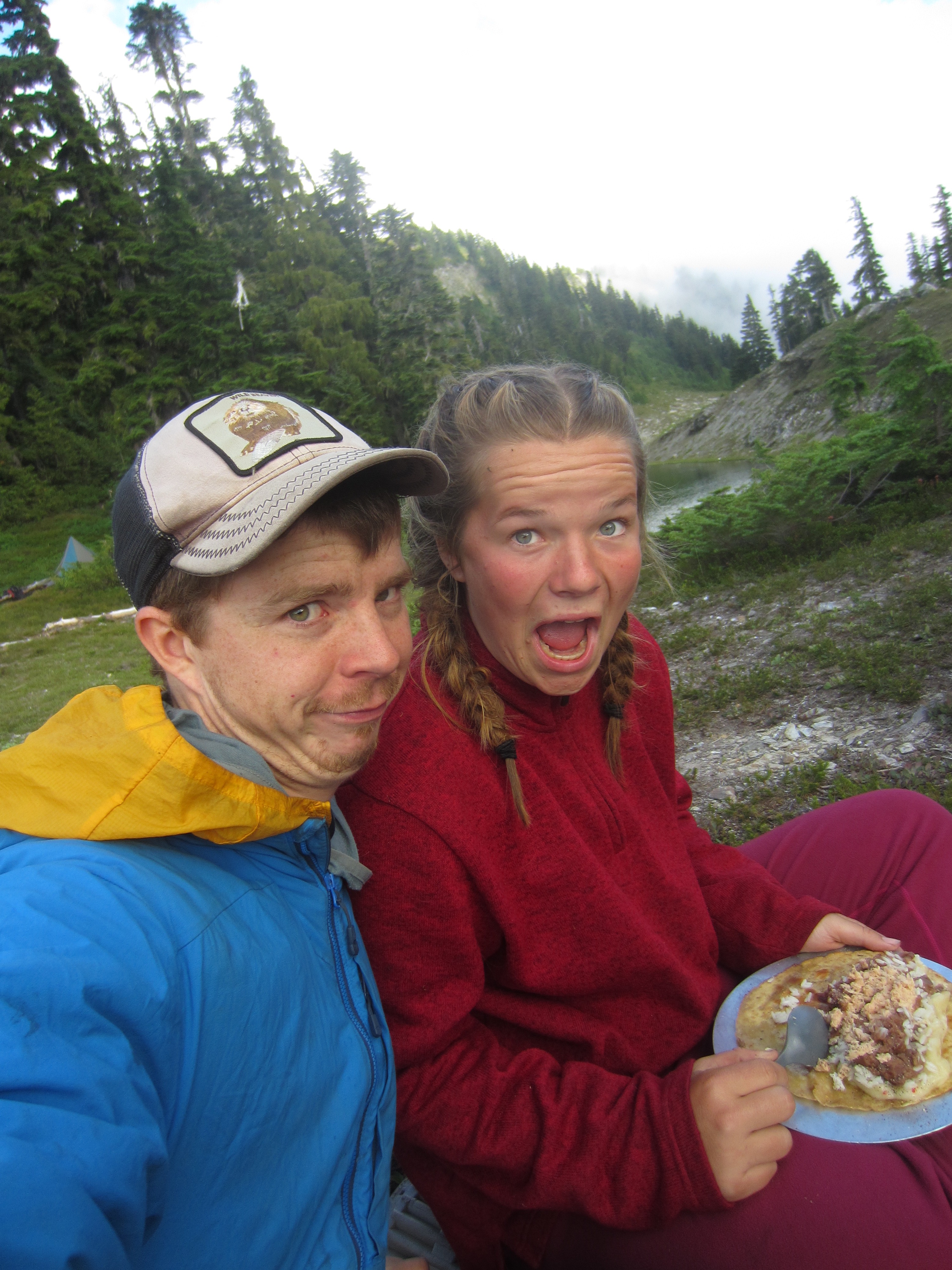 NOLS student and instructor make goofy faces for the camera while eating backcoutry burritos