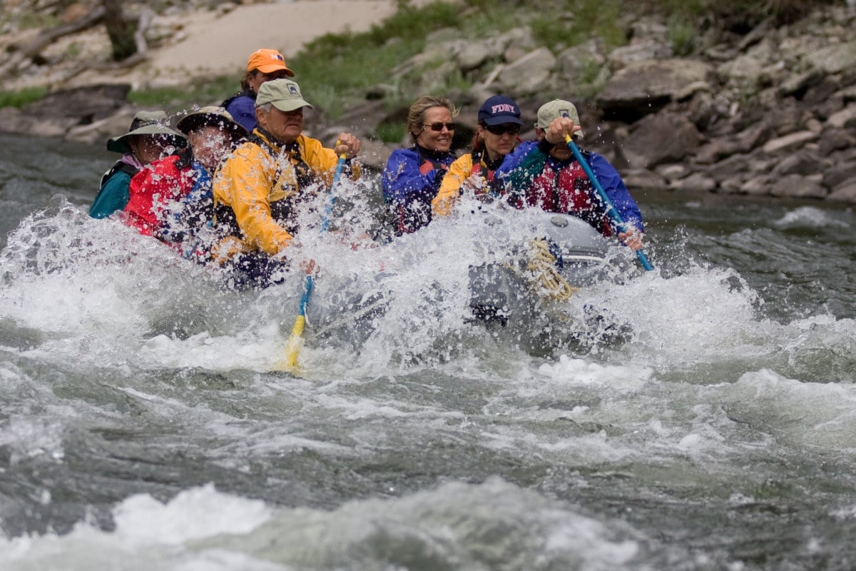 Team rafting through whitewater