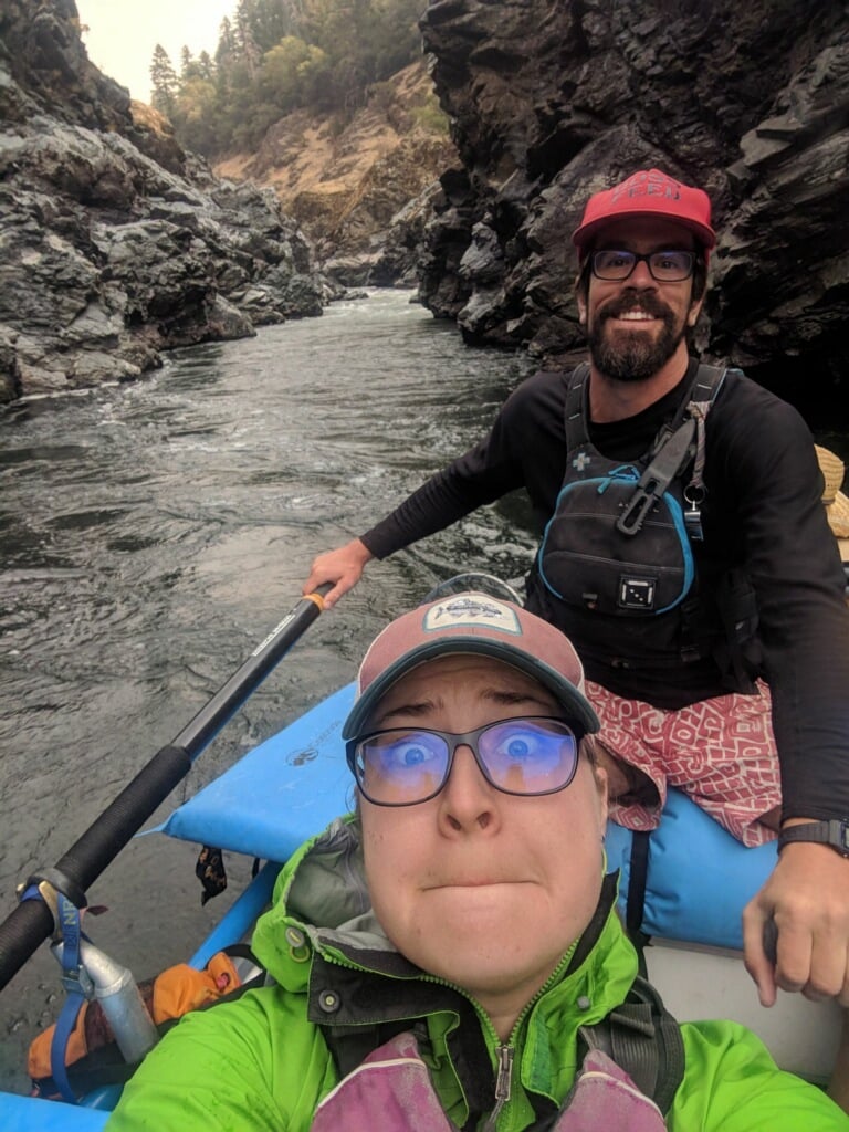 couple in a raft on the river take a selfie while making goofy faces