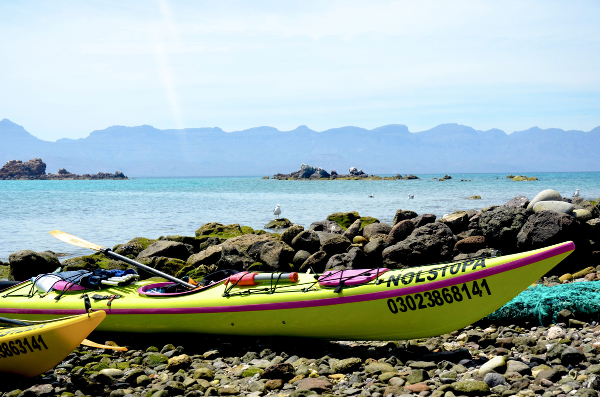Yellow kayak beached on a rocky shore