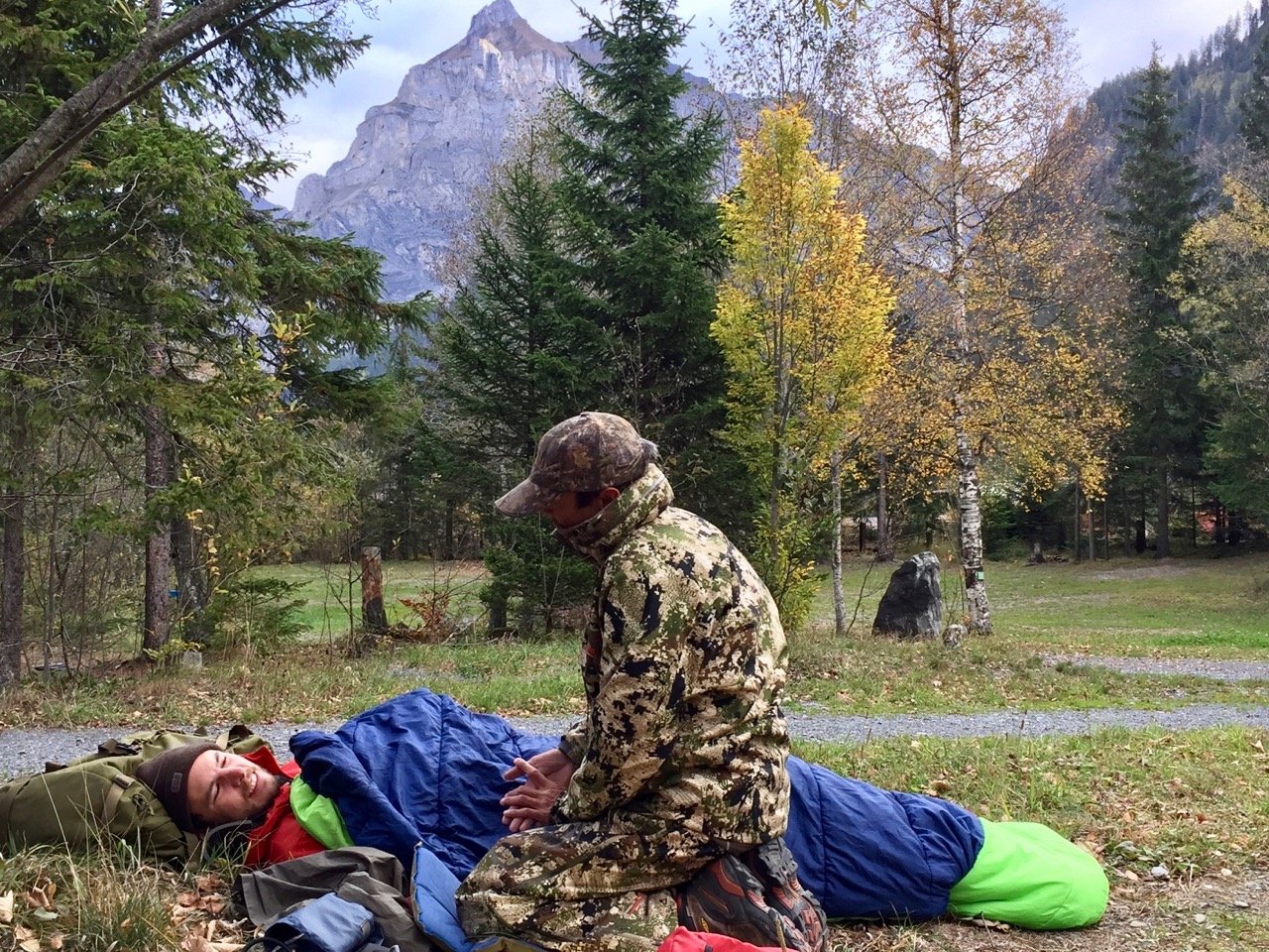 NOLS Wilderness Medicine student practices caring for a patient wrapped in a sleeping bag in the mountains