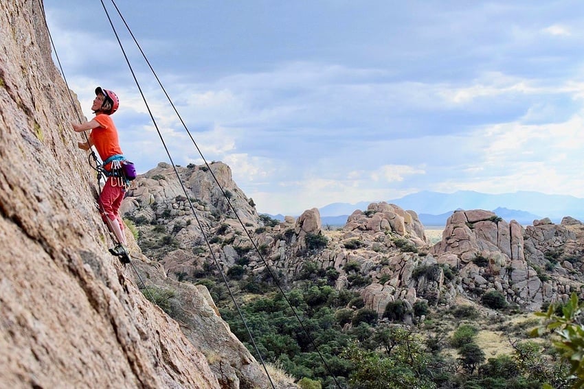 NOLS student mock lead climbs in the Southwest on a women's-only course