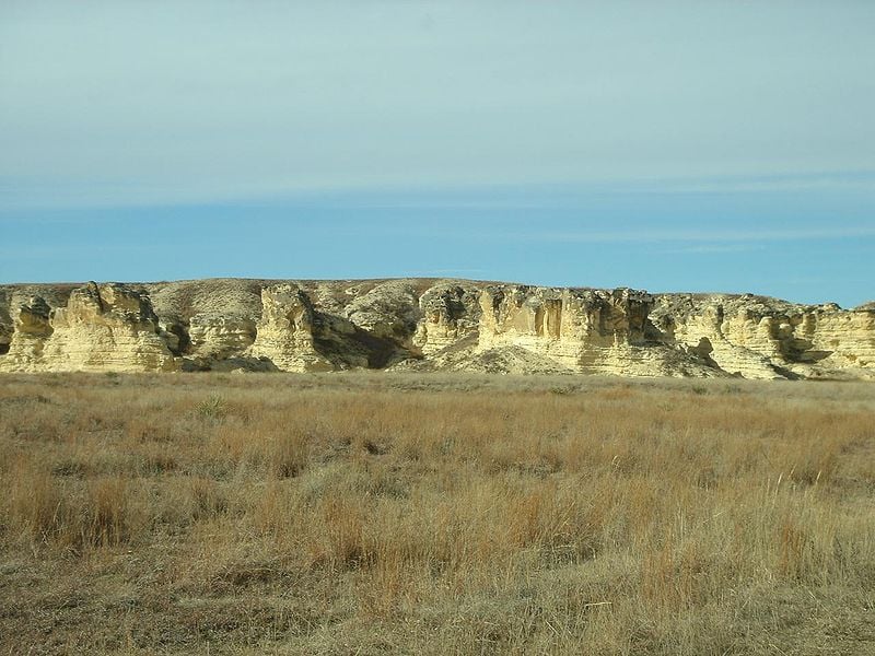 badlands in Kansas with yellow grass and chalk formations