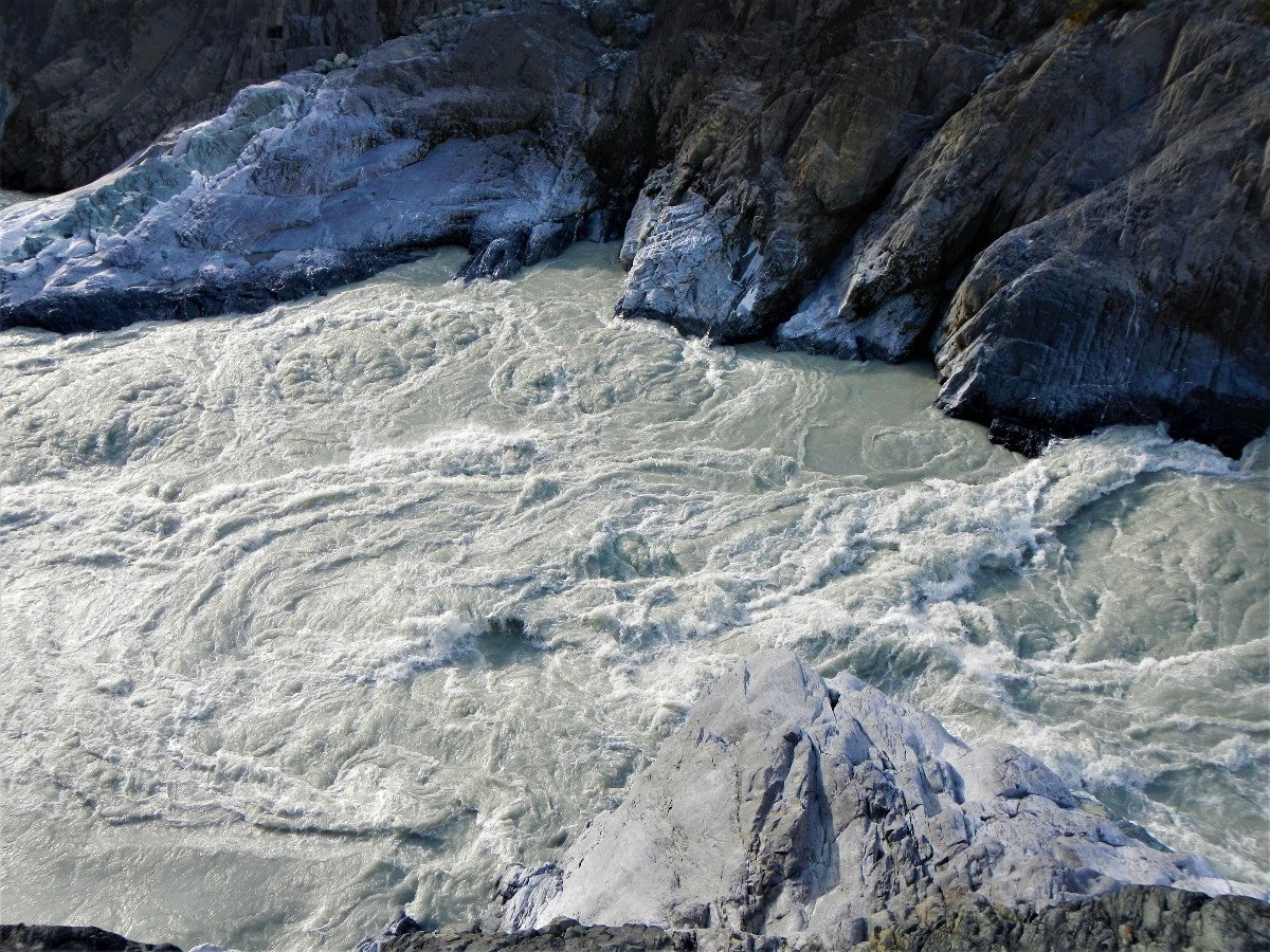 S bends rapid with churning whitewater surrounded by rocky cliffs