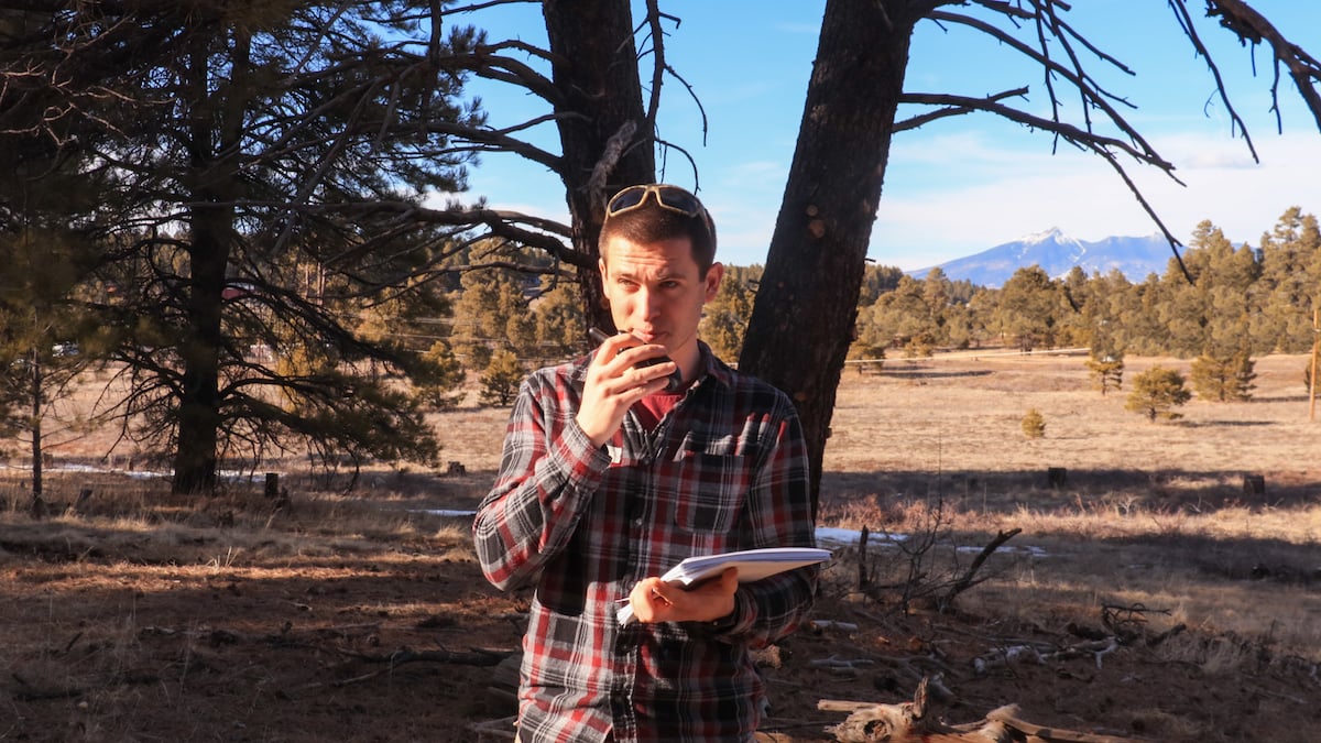 NOLS wilderness medicine student uses a radio to communicate a SOAP note in the outdoors