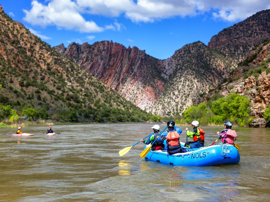 Rafters in an inflatable raft on a desert river