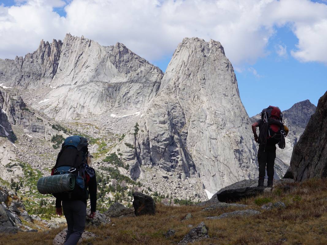Backpackers hike in front of stunning Pingora Peak in the Wind River Range