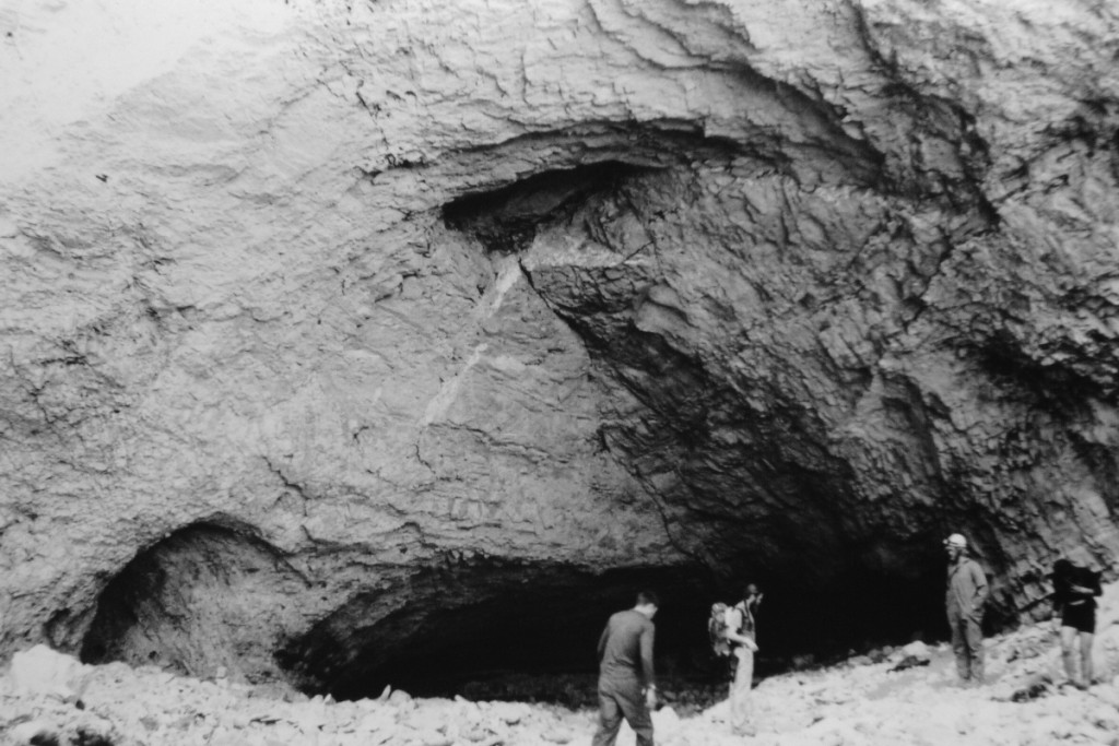 Black and white image of the entrance to Ellison's Cave with rescuers in front
