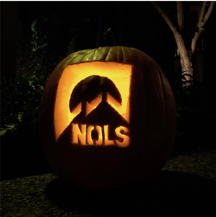 Illuminated NOLS Logo on a pumpkin