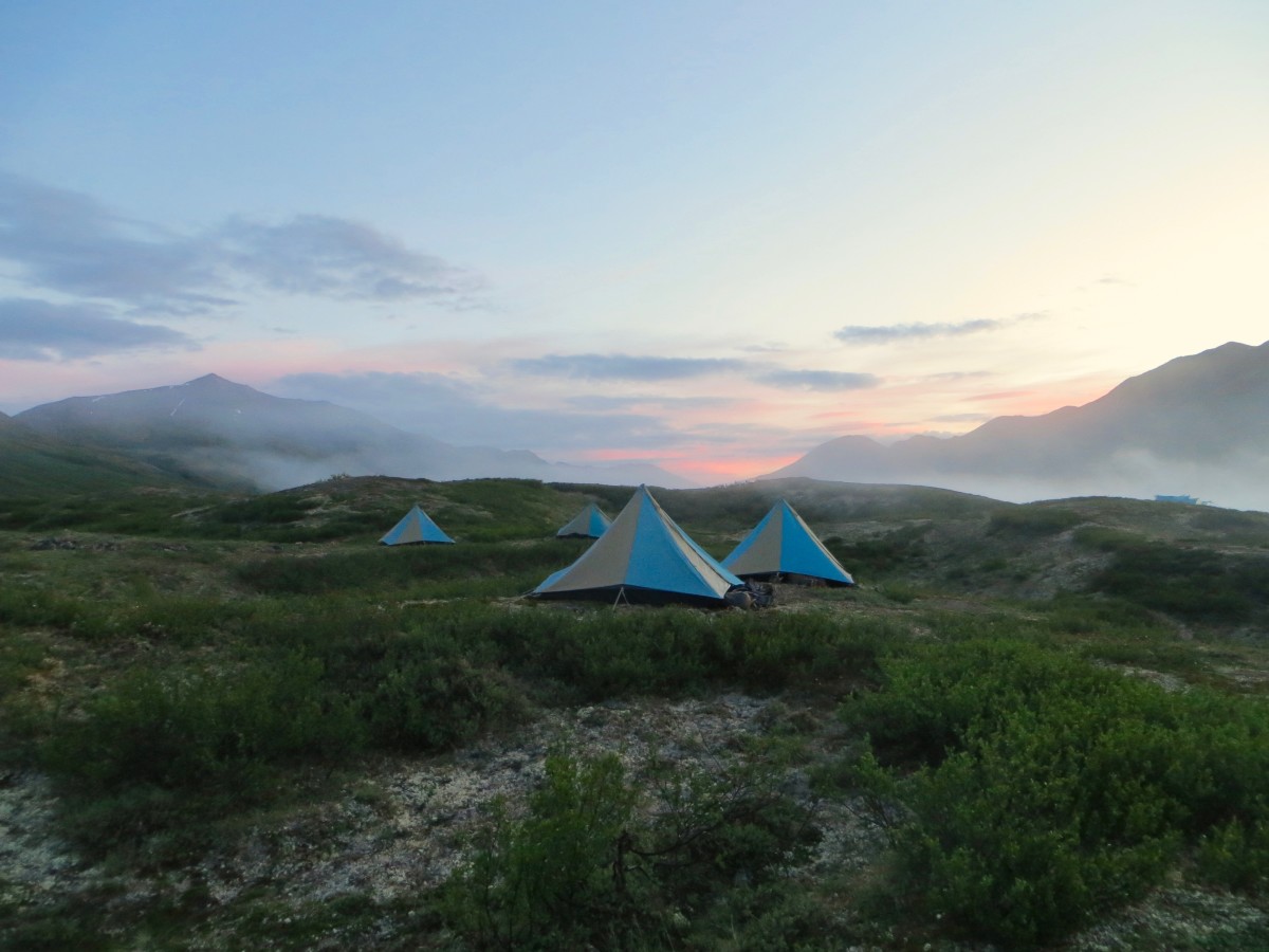 blue and tan mega mid tents pitched in Alaska at sunset