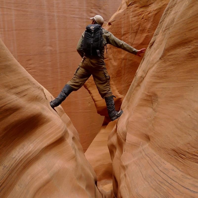 Person hikes in a slot canyon