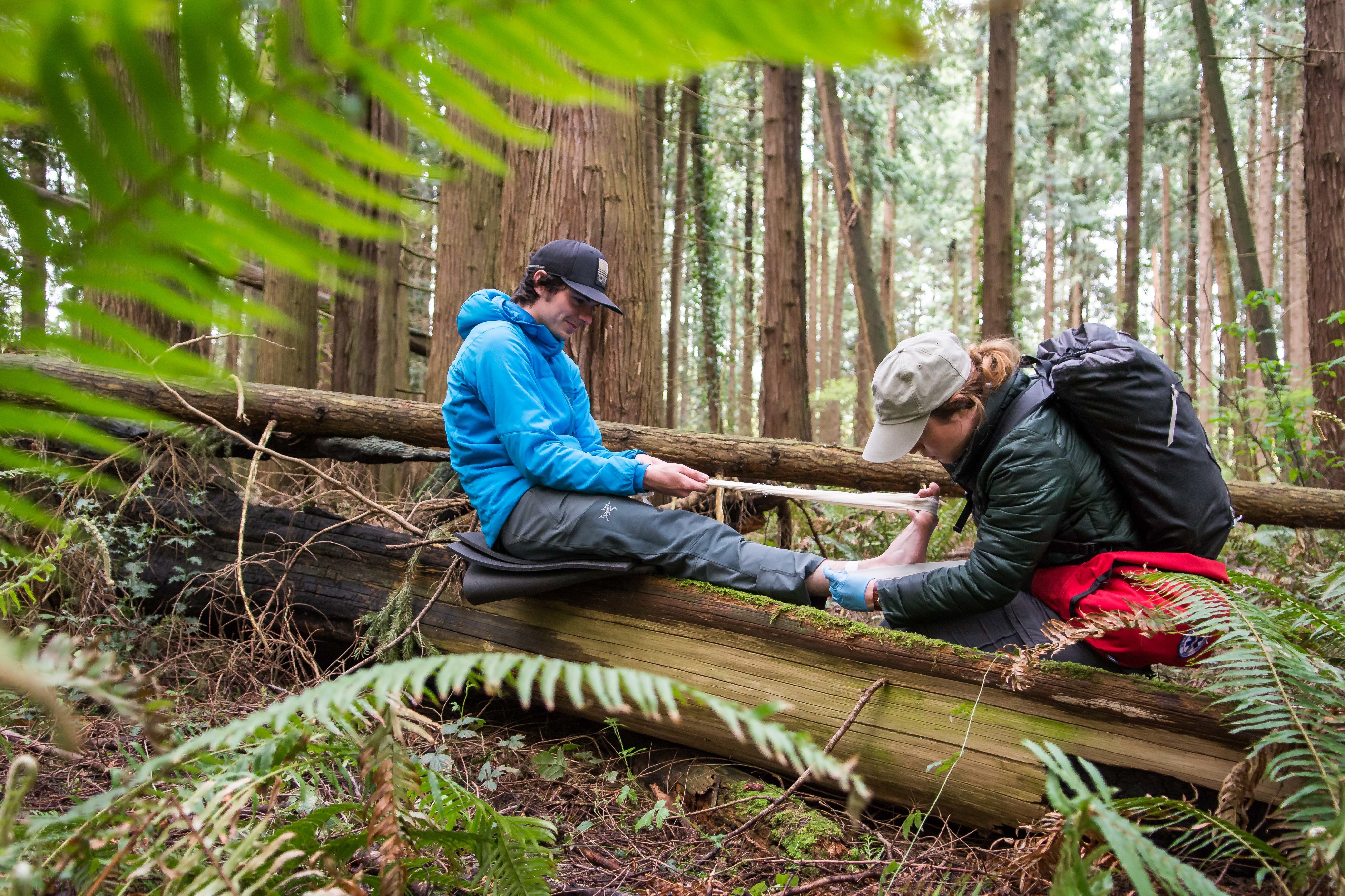 NOLS wilderness medicine student practices caring for patient in the outdoors