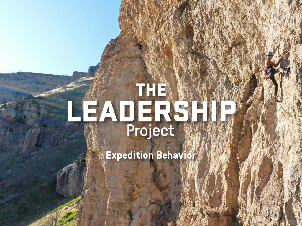 Text overlay of The Leadership Project: Expedition Behavior on a photo of a woman rock climbing