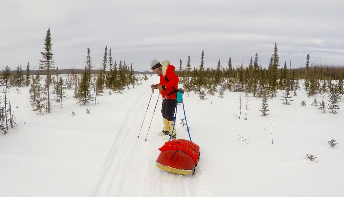 Pete Ripmaster pulls a sled across a snowy Alaskan landscape